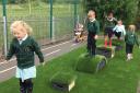 Early years children enjoy the new playground