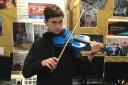 Volodymyr Podobiedov, who is passionate about playing the violin
