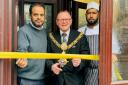 Town mayor Cllr John Kirby performs the ribbon cutting, with Ashraf Miah, left, and Lilu Miah