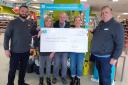 Silsden Co-op’s Luke Harmer, left, and store manager Mark Millman, right, present a cheque to the Friends of Silsden’s Green Places