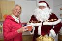 Santa receives a cuppa from Haworth Bowling Club’s Christine Harker