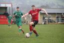 Silsden's Ross Daly (red) on the ball against high-flying Garforth on Saturday.