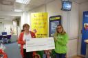 Debbie Ergene, left, from the Halifax, presents a cheque to Manorlands fundraising assistant Jodie Batters