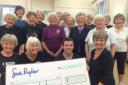 Manorlands fundaiser Matthew Palmer accepts a £400 cheque from members of Cononley Ladies Keep Fit Group