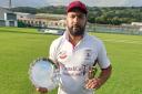 Mohammed Gulnawaz proudly holds the Manorlands Plate and the man of the match award.
