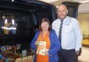 Julie Guilfoyle, of Aireworth Dogs in Need, and Adrian Shotton from the dealership with some donated items