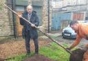 Cllr Zafar Ali helps with the tree planting