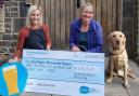 Manorlands' Hayley Ibbotson, left, receives a cheque from Sarah Schofield