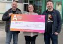 Jodie Hearnshaw – of Airedale Hospital and Community Charity – receives a cheque from Mike Burtoft, left, and Scott Goodwin