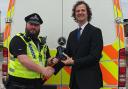 Councillor Alex Ross-Shaw presents the new equipment to the police