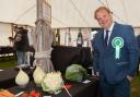 Last year's show president Andrew Wood admires some of the veg exhibits
