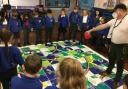 Peter Bell works with pupils at Kildwick Primary School