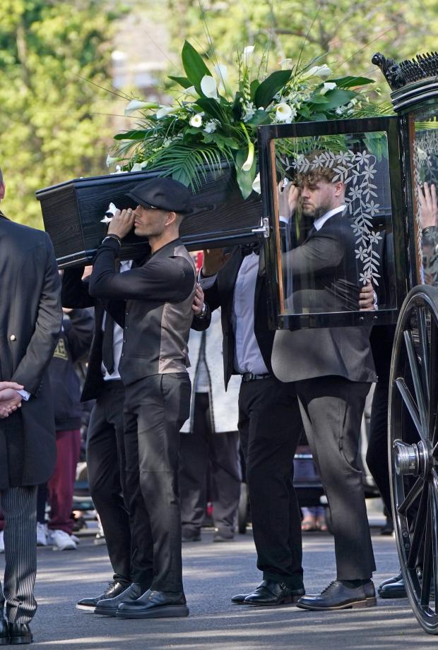 Keighley News: Max George and Jay McGuiness of The Wanted carry the coffin at the funeral of their bandmate. (PA)