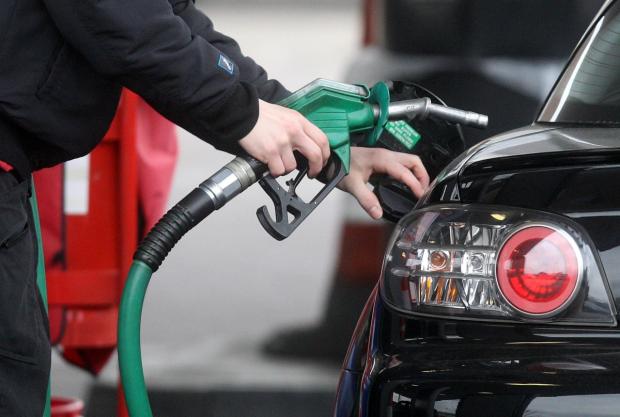 Keighley News: Someone using a fuel pump at a petrol station (PA)
