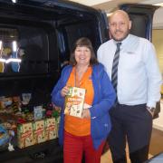 Julie Guilfoyle, of Aireworth Dogs in Need, and Adrian Shotton from the dealership with some donated items