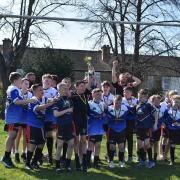 Keighley Albion's Under-10s lift the North/South Challenge Trophy.