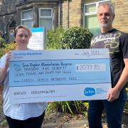 Cath and Tony Anderton present a cheque to Manorlands