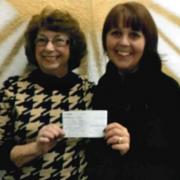 Carole Ogden, left, presents the cheque to the Rev Natasha Thomas