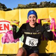 Helen Smith, from Oxenhope, posing with two Soreen malt loaves after victory in the Stanbury Splash women's race. Picture: Dave Woodhead/WoodenTops.