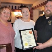 CAMRA branch vice chair, Julie Boyle, presents the award to Emma Louise Jeffrey and Paul Feather of the Brown Cow