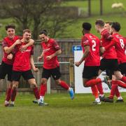 Silsden's top goalscorer Luke Brooksbank (second left) is mobbed after scoring what turned out to be the winner in their derby against Thackley on Saturday. Picture: Martin Taylor.