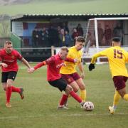 Kyle Hancock (second left) came close to giving Silsden the lead last night, only for Barton to grab their winner moments later.