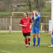 Jack Normanton (red) offers a marked contrast to the Goole defenders, as he celebrates finding the net on Saturday.