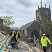 Steve Matthews, left, of Pinnacle Conservation Ltd, at work on the roof, pictured with Bronte Spirit trustee John Collinson