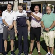 The winning team from the golf day, with its trophy