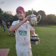 Cononley skipper Harry Parker lifts the Cowling Cup. Picture: Bill Marshall