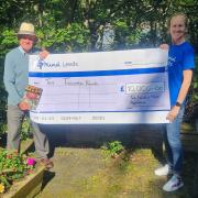 Edward Evans presents a cheque to Gemma Green, community fundraiser for Leeds Mind