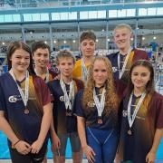 Denholme's Amy Hagyard (left) and Keighley's Quinn Austin-Kelly (third left) were among the City of Bradford swimmers to shine in Sheffield.