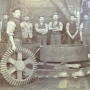 A workman with a pattern for a bevel wheel, and colleagues, at Eastburn Foundry