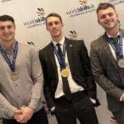 Gold medal winner Harry Pullan, centre, with two fellow WorldSkills UK finalists