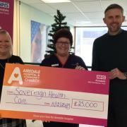 Nicola Denbow, centre, matron in the emergency department, receives a cheque from Barbara Keiss and Neil McCallum of Sovereign Health Care