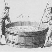 An 18th-century illustration of two men scouring wool with paddles
