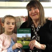 Carol Morrell Smith and granddaughter Evelyn Shaw with a copy of the book