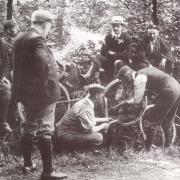 Members of Keighley Cycling Club attending to a repair, in about 1910