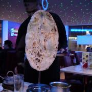 Serving up one of the giant naan breads at the Shimla Spice restaurant in Keighley