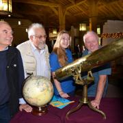 STAR GAZING: Viewing a 1800s telescope at the Astrofestival at East Riddlsden Hall are, (from left), Rod Levene, Rod Hine) Kate Struthers, and John Bardsley