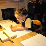 A pupil of Haworth Primary School helping write the new manuscript for Emily Brontë’s Wuthering Heights