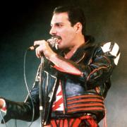 FILE - In this 1985 file photo, singer Freddie Mercury of the rock group Queen, performs at a concert in Sydney, Australia. Queen guitarist Brian May says an asteroid in Jupiter's orbit has been named after the band's late frontman Freddie