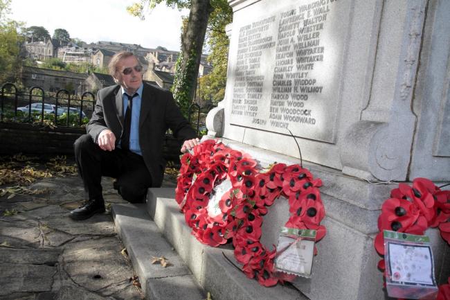 Parish councillor Alan Watts next to Haworth War Memorial